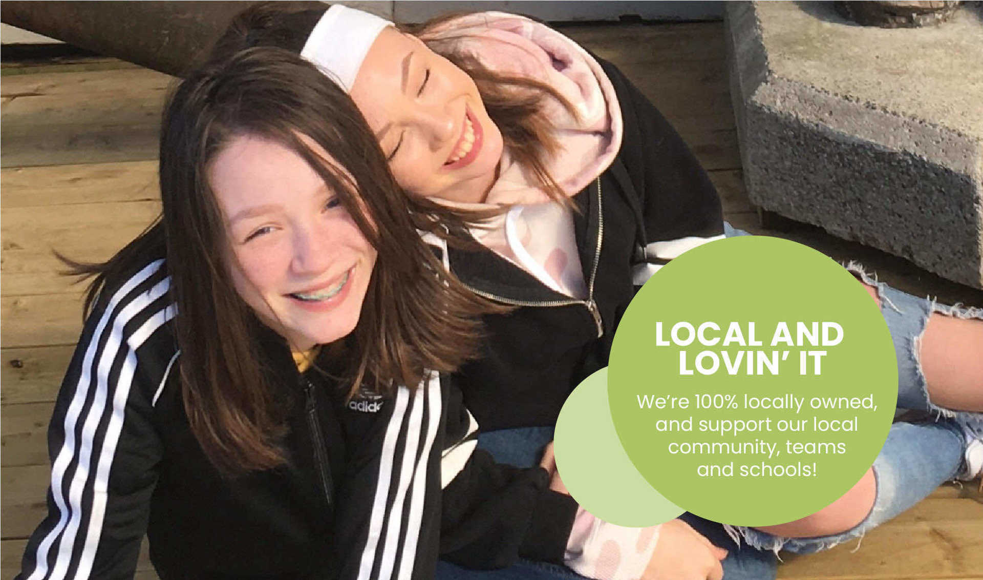 Two girls sitting together smiling